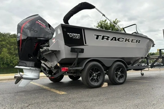 Slide: The Image of 2027 Tracker Targa V-18 WT boat on trailer, featuring sleek design and powerful engine. - 14