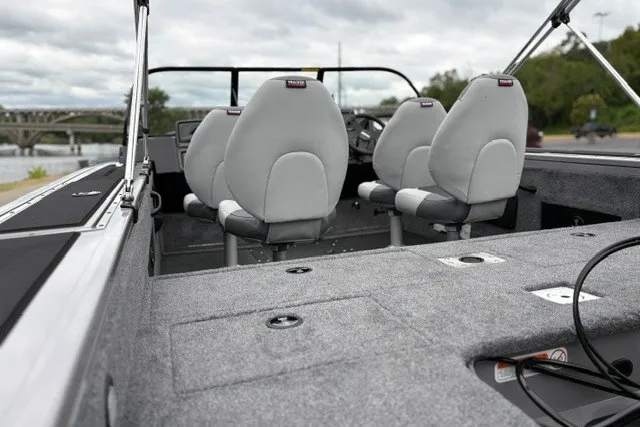 Slide: The Image of 2027 Tracker Targa V-18 WT boat interior with gray seating and carpeted flooring. - 17