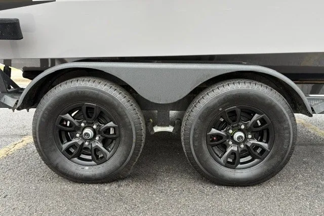 Slide: The Image of Dual black wheels on a 2027 Tracker Targa V-18 WT boat trailer. - 16