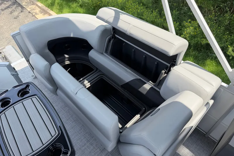 Slide: The Image of 2027 Sun Tracker Party Barge 22 DLX interior with open storage compartments and seating. - 18