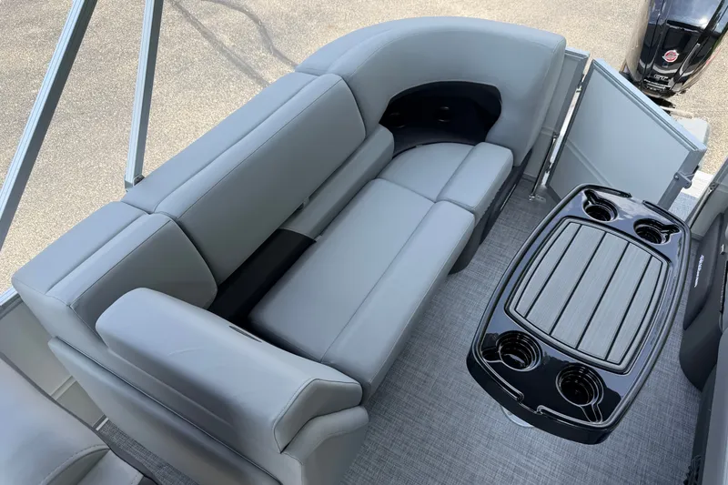Slide: The Image of 2027 Sun Tracker Party Barge 22 DLX interior with gray seating and a sleek table. - 19