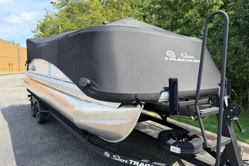Slide: The Image of 2027 Sun Tracker Party Barge 22 DLX pontoon boat covered on trailer. - 24