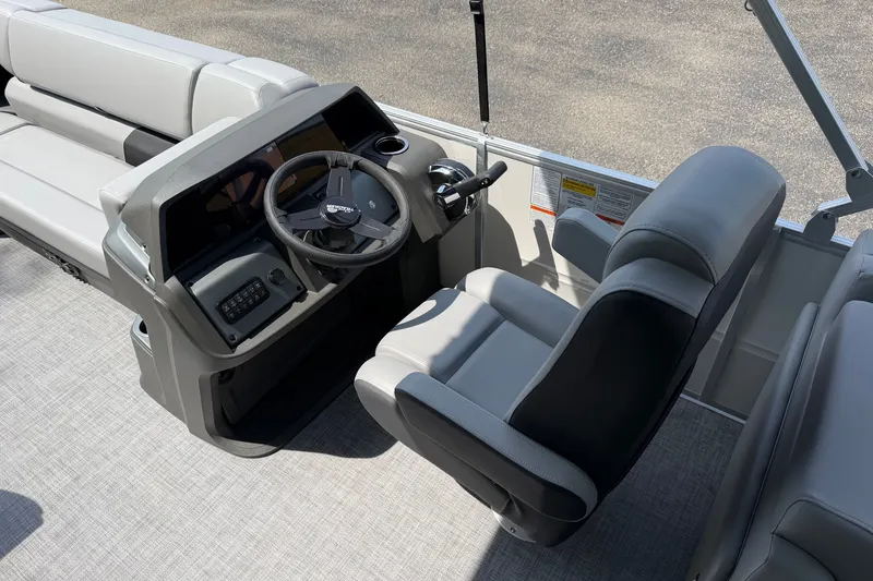 Slide: The Image of 2027 Sun Tracker Party Barge 22 DLX interior with steering console and seating. - 15
