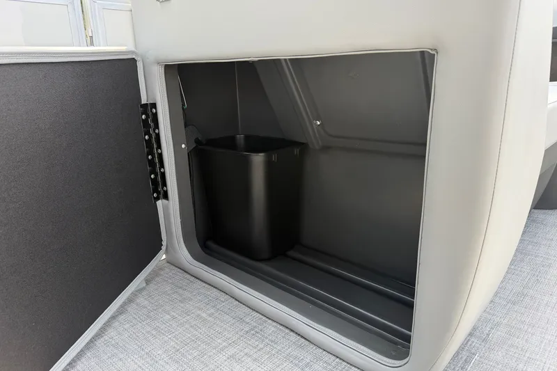 Slide: The Image of Storage compartment with trash bin in 2027 Sun Tracker Party Barge 22 DLX. - 14