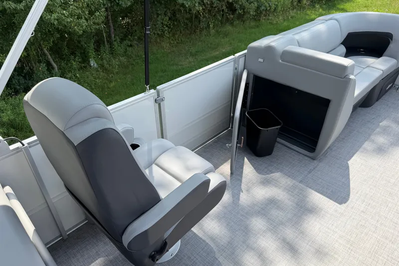 Slide: The Image of 2027 Sun Tracker Party Barge 22 DLX interior with seating and storage. - 13