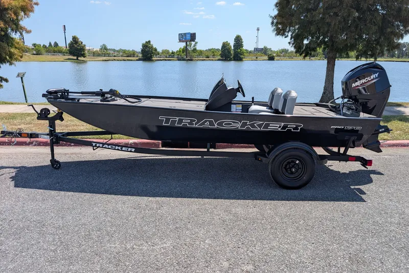 The Image of 2027 Tracker Pro 170 boat on trailer by a lake, sunny day. - 0