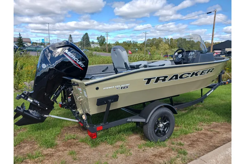 The Image of 2027 Tracker Pro Guide V-16 SC boat with Mercury engine on trailer, outdoors. - 0