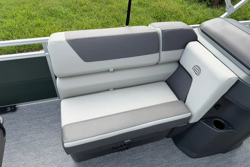Slide: The Image of 2027 Sun Tracker Fishin' Barge 22 DLX boat seat, gray and white upholstery, cup holder. - 16