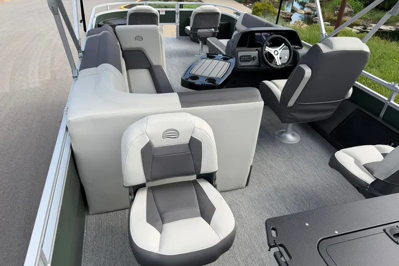 Slide: The Image of Interior view of 2027 Sun Tracker Fishin' Barge 22 DLX pontoon boat with seating and helm. - 27