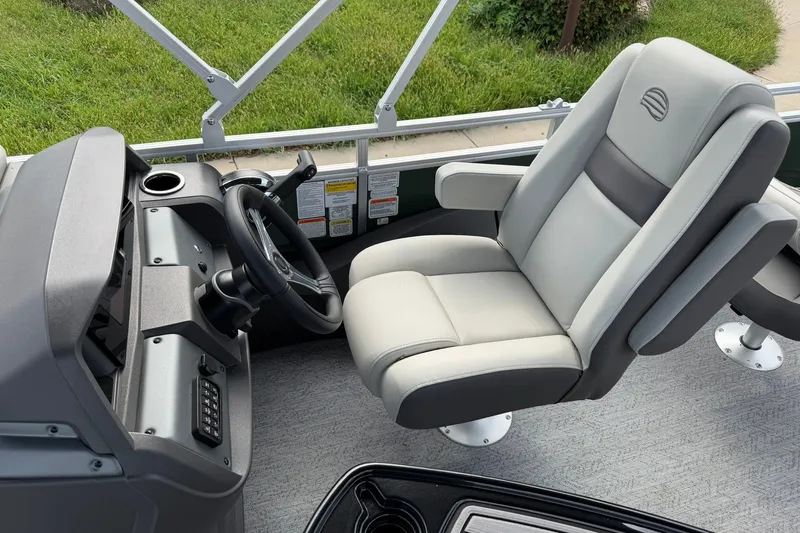 Slide: The Image of 2027 Sun Tracker Fishin' Barge 22 DLX helm with comfortable captain's chair and steering wheel. - 19