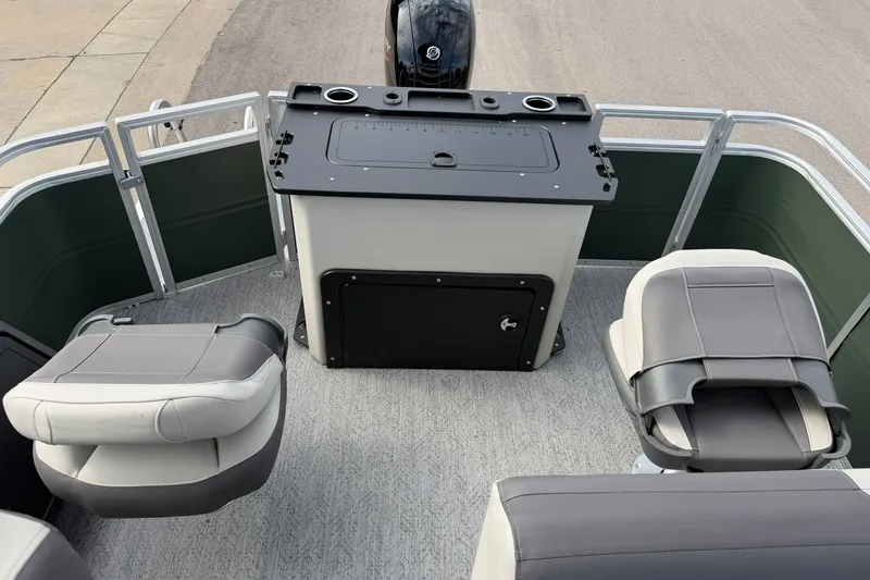 Slide: The Image of 2027 Sun Tracker Fishin' Barge 22 DLX interior with seating and fishing station. - 23