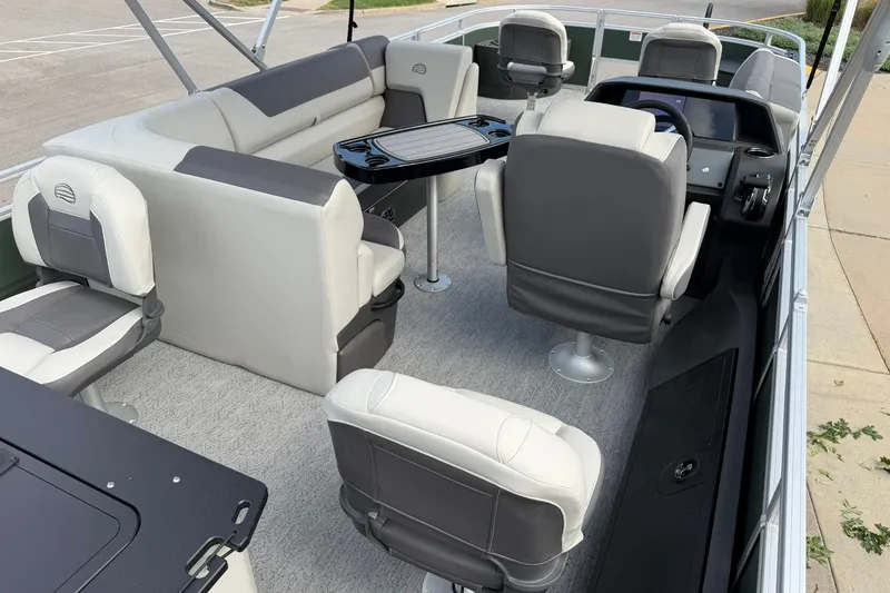 Slide: The Image of 2027 Sun Tracker Fishin' Barge 22 DLX interior with seating and helm station. - 28