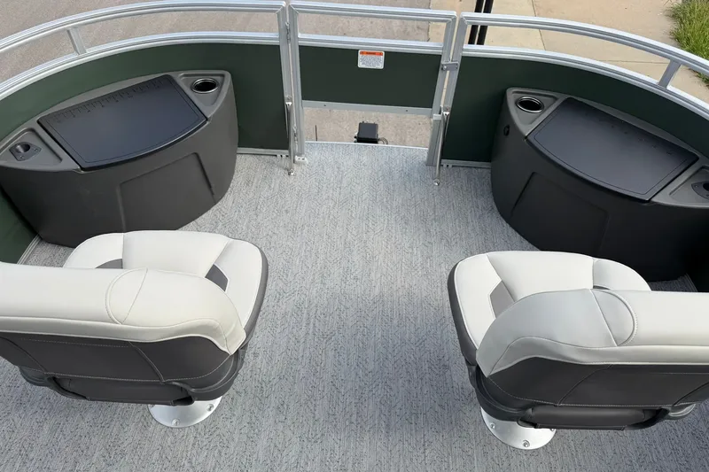 Slide: The Image of 2027 Sun Tracker Fishin' Barge 22 DLX interior with two swivel seats and storage compartments. - 15