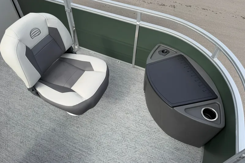 Slide: The Image of 2027 Sun Tracker Fishin' Barge 22 DLX interior with cushioned seat and storage compartment. - 14