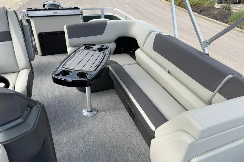 Slide: The Image of 2027 Sun Tracker Fishin' Barge 22 DLX interior with seating and table, ideal for leisure. - 17