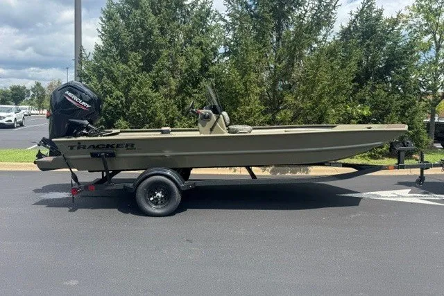 The Image of 2027 Tracker Grizzly 1860 CC boat on trailer, parked outdoors. - 0