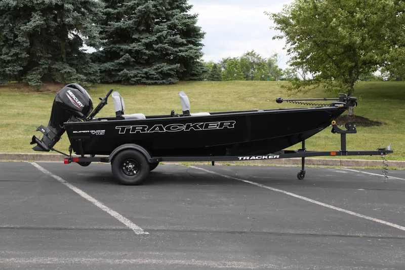 The Image of 2027 Tracker Super Guide V-16 T boat on trailer, parked outdoors. - 0