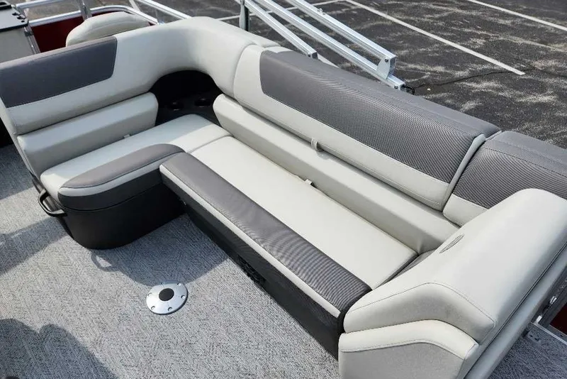 Slide: The Image of 2027 Sun Tracker Fishin' Barge 22 DLX interior seating, featuring gray and white upholstery. - 15