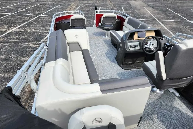 Slide: The Image of 2027 Sun Tracker Fishin' Barge 22 DLX interior with seating and steering console. - 17