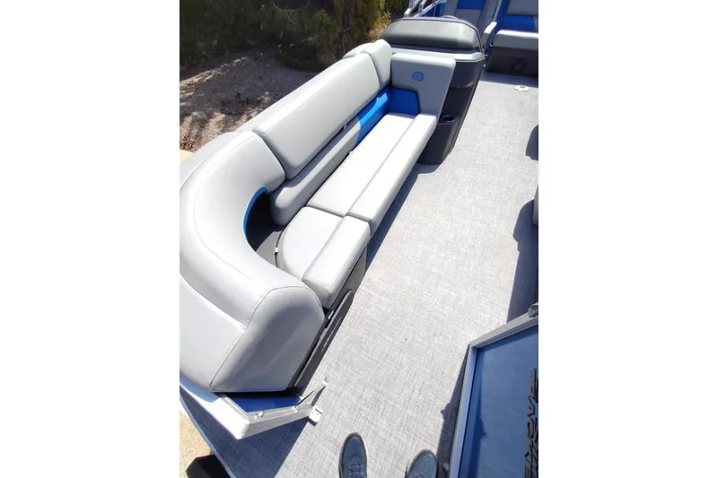 Slide: The Image of 2027 Sun Tracker Party Barge 20 DLX interior with gray seating and blue accents. - 14