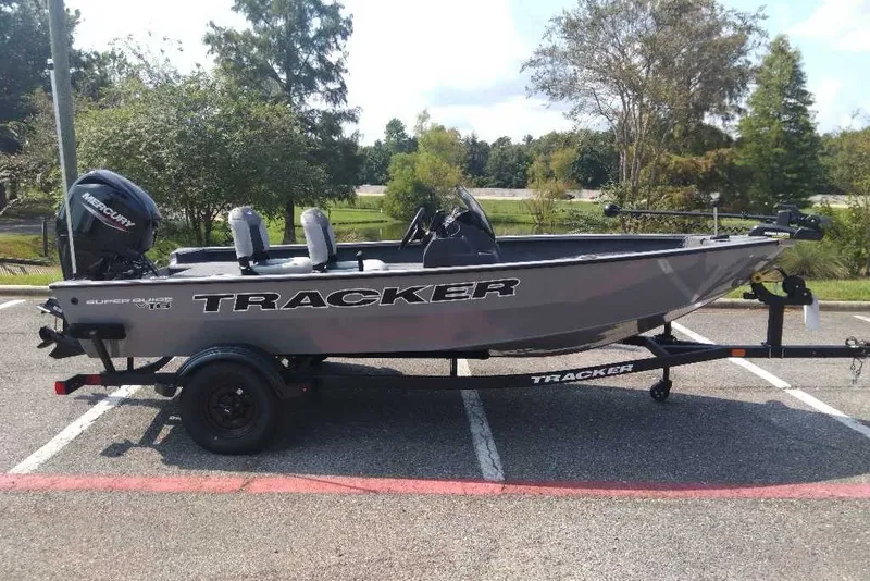 The Image of 2027 Tracker Super Guide V-16 SC boat on trailer in parking lot. - 0