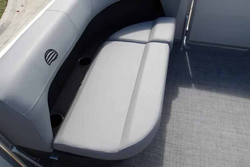 Slide: The Image of 2027 Sun Tracker Party Barge 16 DLX interior with gray seating and cup holders. - 16
