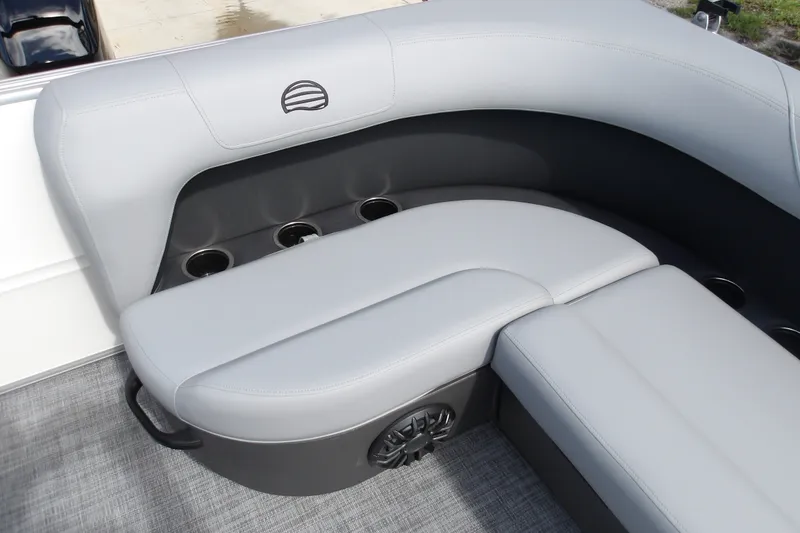 Slide: The Image of 2027 Sun Tracker Party Barge 16 DLX interior seating with cup holders and speaker. - 14