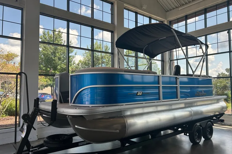 The Image of 2027 Sun Tracker Party Barge 22 DLX pontoon boat displayed indoors with blue exterior. - 0