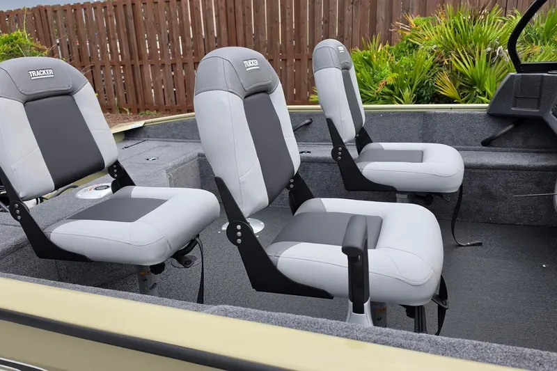 Slide: The Image of 2027 Tracker Pro Guide V-16 WT boat interior with three gray seats. - 15