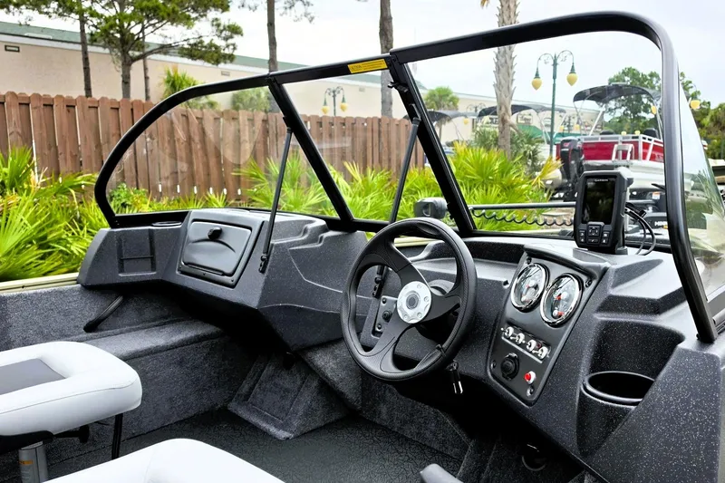 Slide: The Image of 2027 Tracker Pro Guide V-16 WT boat interior with steering wheel and dashboard controls. - 14