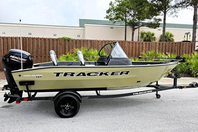 The Image of 2027 Tracker Pro Guide V-16 WT boat on trailer, parked outdoors. - 0