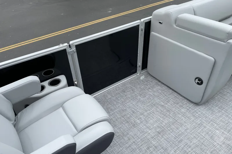 Slide: The Image of 2027 Sun Tracker Party Barge 22 DLX interior with gray seating and cup holders. - 21
