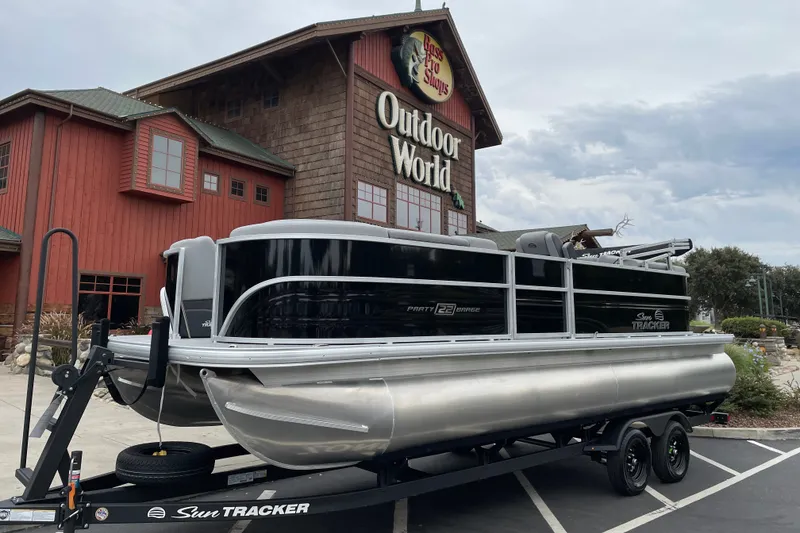 The Image of 2027 Sun Tracker Party Barge 22 DLX pontoon boat outside Bass Pro Shops Outdoor World. - 0