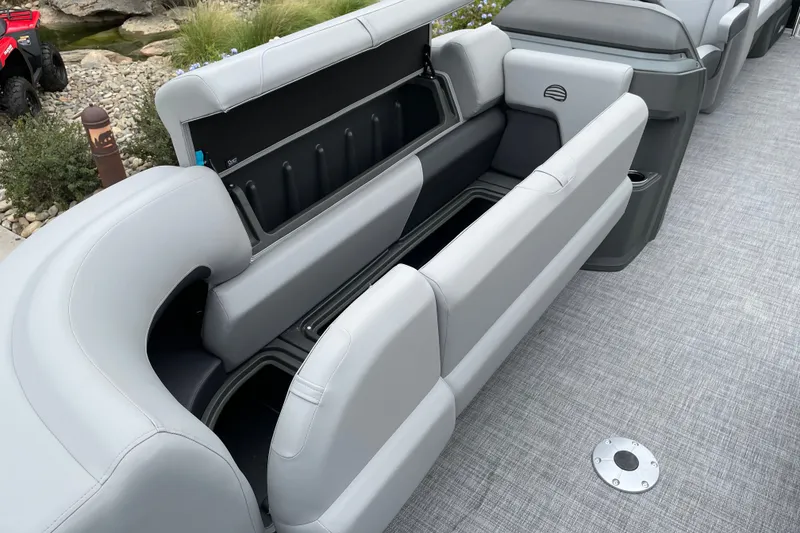 Slide: The Image of 2027 Sun Tracker Party Barge 22 DLX with open storage compartments on deck. - 14