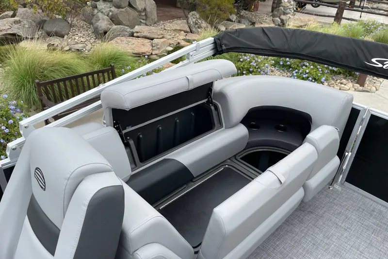 Slide: The Image of 2027 Sun Tracker Party Barge 22 DLX interior with gray seating and storage compartments. - 16
