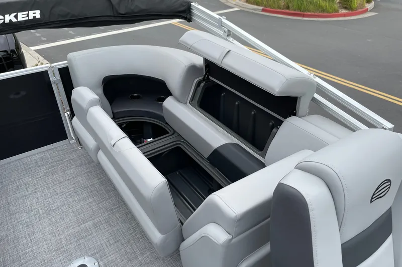 Slide: The Image of 2027 Sun Tracker Party Barge 22 DLX interior seating with storage compartments open. - 18