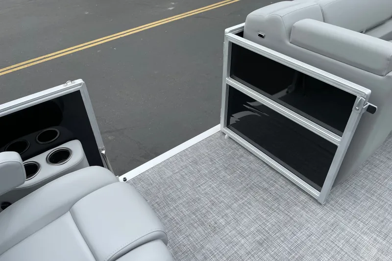 Slide: The Image of 2027 Sun Tracker Party Barge 22 DLX interior with gray seating and cup holders. - 22