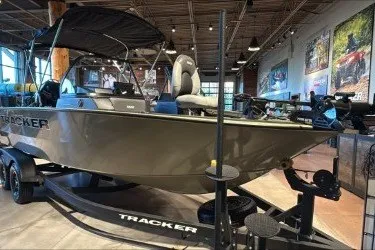 The Image of 2027 Tracker Targa V-18 WT boat displayed in showroom, featuring sleek design and modern amenities. - 0