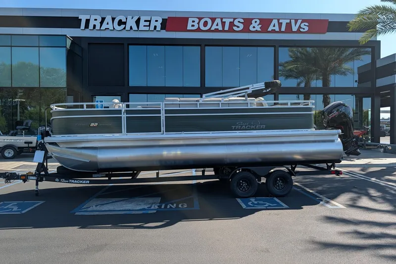 The Image of 2027 Sun Tracker Fishin' Barge 22 DLX pontoon boat at dealership. - 0