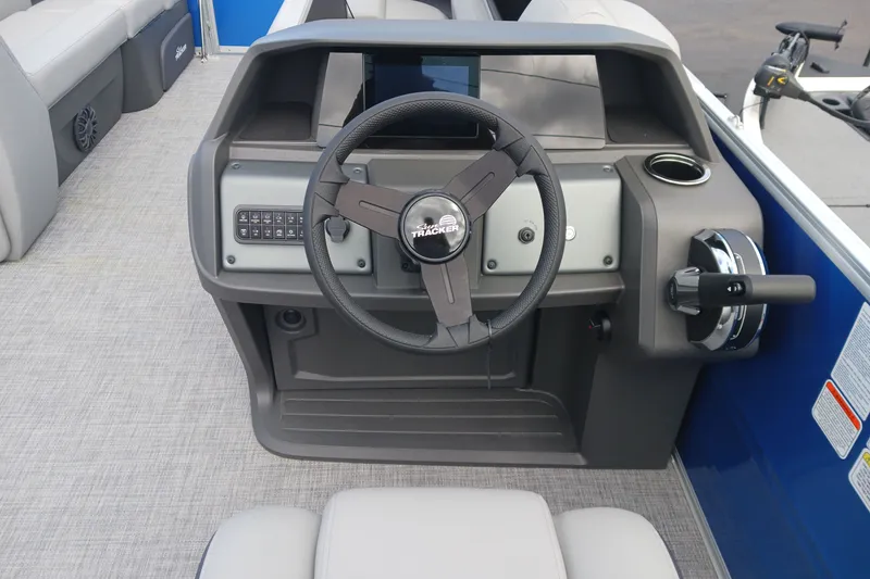 Slide: The Image of 2027 Sun Tracker Party Barge 20 DLX steering console with modern controls and seating. - 78