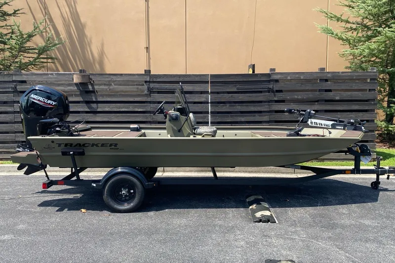 The Image of 2027 Tracker Grizzly 1860 CC boat on trailer, parked outdoors. - 0