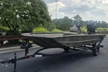 The Image of 2027 Tracker Grizzly 1860 CC boat on trailer, parked outdoors. - 0