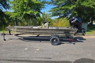 The Image of 2027 Tracker Grizzly 1860 CC boat on trailer, parked outdoors. - 0