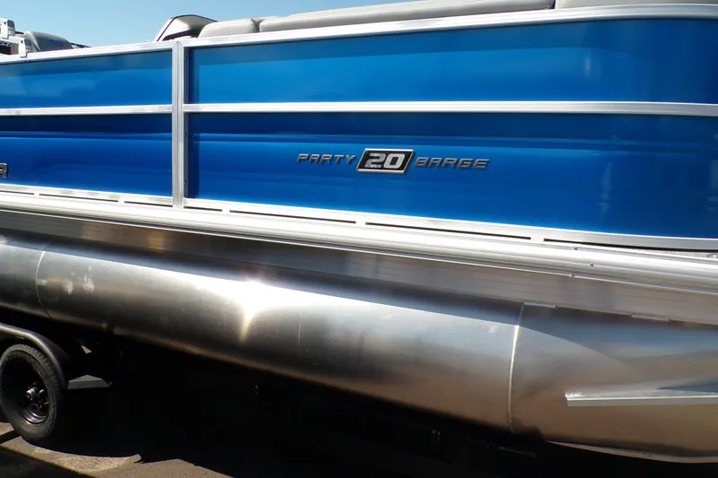 The Image of 2027 Sun Tracker Party Barge 20 DLX pontoon boat with blue exterior and sleek design. - 0