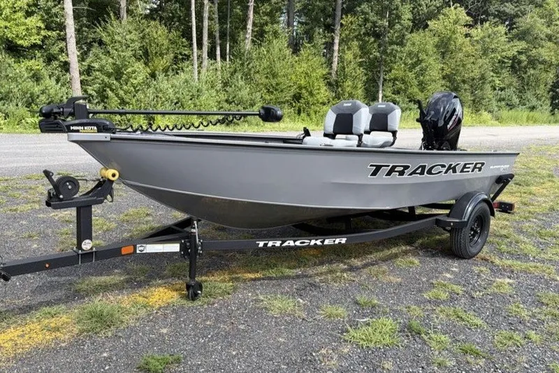 The Image of 2027 Tracker Super Guide V-16 T boat on trailer, parked outdoors. - 0