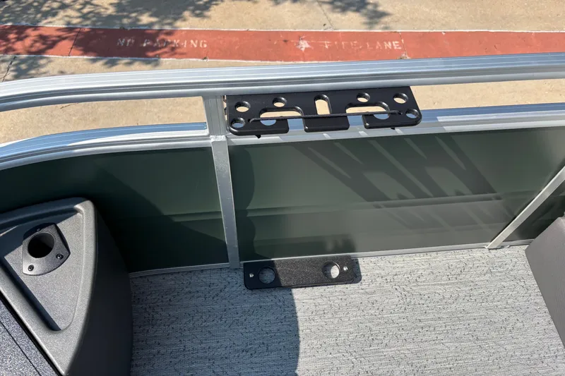 Slide: The Image of Sun Tracker Fishin' Barge 22 DLX 2027 interior detail with railing and mounting bracket. - 13