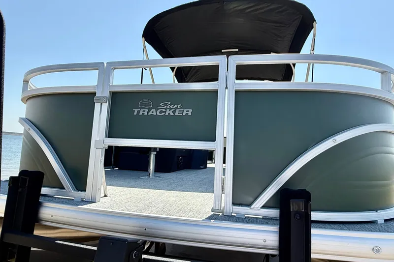 Slide: The Image of 2027 Sun Tracker Fishin' Barge 22 DLX pontoon boat with sleek design on a sunny day. - 20
