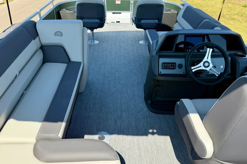 Slide: The Image of 2027 Sun Tracker Fishin' Barge 22 DLX interior with seating and steering console. - 18