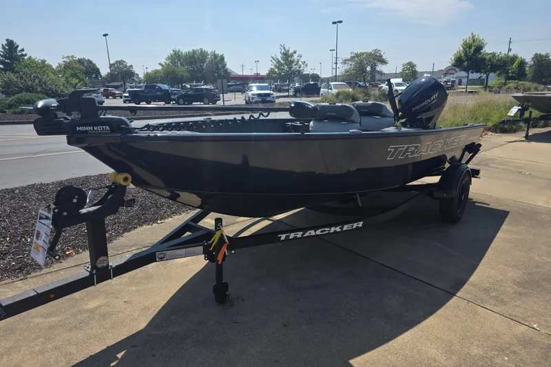 The Image of 2027 Tracker Super Guide V-16 T boat on trailer, parked outdoors. - 0
