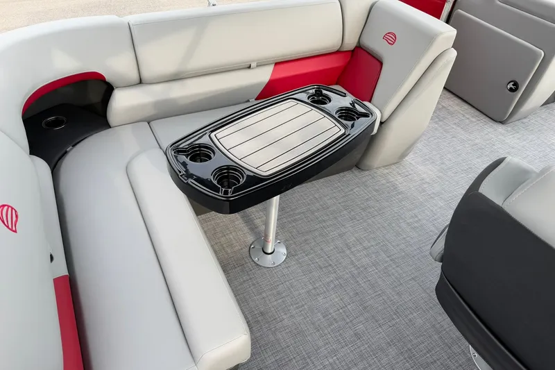Slide: The Image of 2027 Sun Tracker Party Barge 20 DLX interior with seating and table, featuring cup holders. - 18